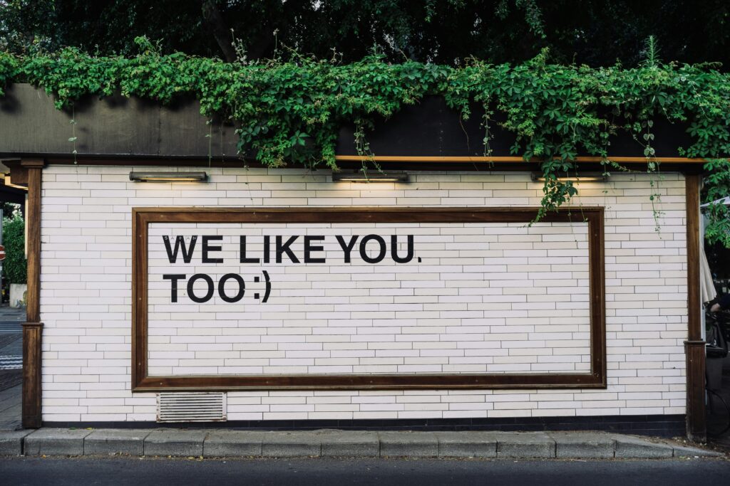 wall with We like you too written on it representing reviews and feedback