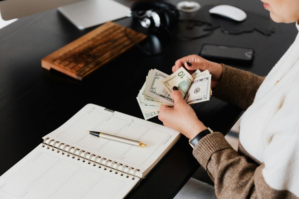 person counting money representing Digital Marketing on a Budget